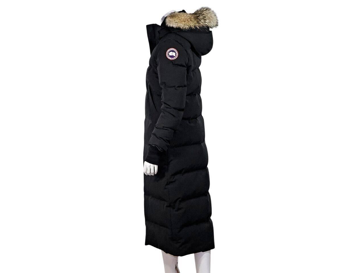 Product details:  Long black parka by Canada Goose.  Detachable fur-trimmed hood.  Long sleeves.  Ribbed cuffs.  Zip-front closure.  Waist slide pockets.  
Condition: Pre-owned. Very good.
Est. Retail $ 995.00