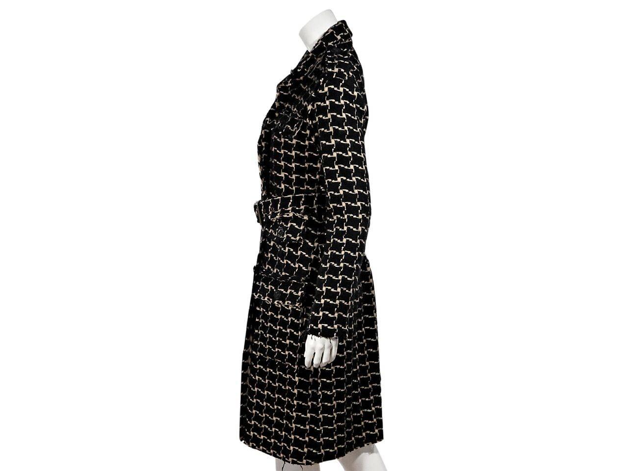 Product details:  Black and tan wool oversized houndstooth coat by Lanvin.  Raw edge trimming.  Notched lapel.  Long sleeves.  Shoulder epaulettes.  Adjustable belted waist.  Button-front closure.  Button flap chest and waist pockets.  
Condition: