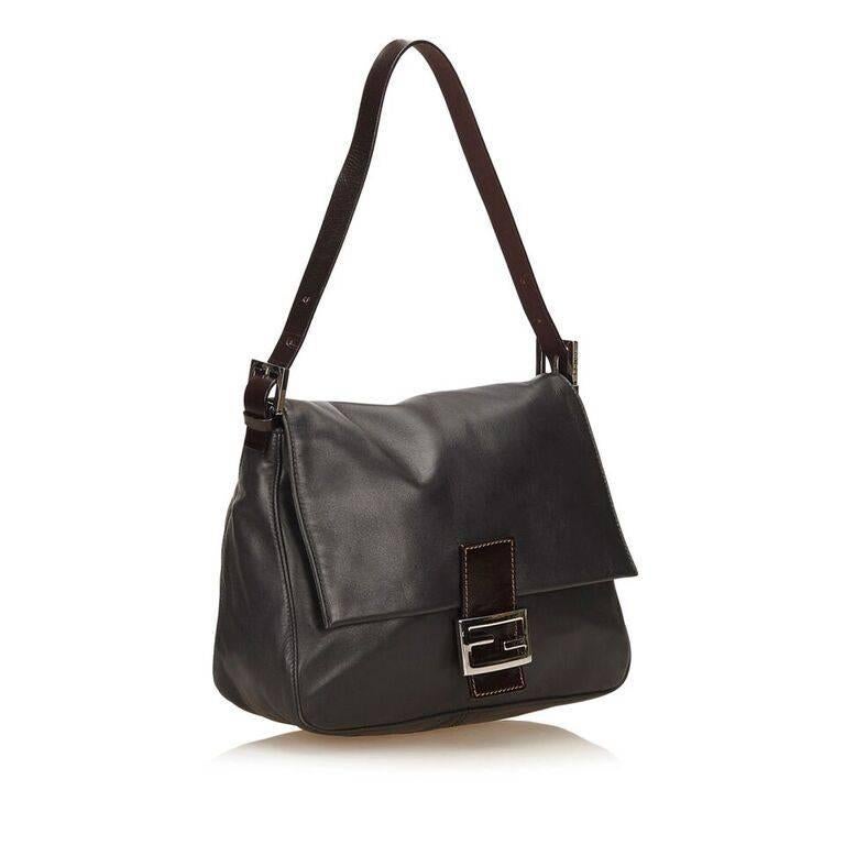 Product details:  Black leather Baguette shoulder bag by Fendi.  Single shoulder strap.  Front flap with logo buckle strap.  Magnetic snap closure.  Lined interior with inner zip pocket.  Silvertone hardware.  Dust bag included.  10.5