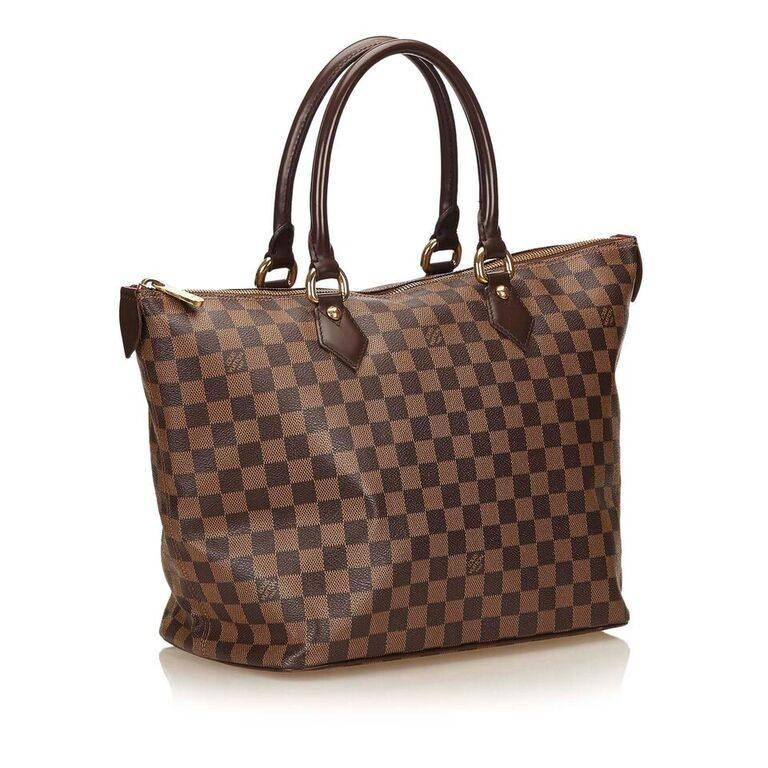 Product details:  Brown damier ebene canvas tote bag by Louis Vuitton.  Dual carry handles.  Top zip closure.  Lined interior with inner zip pocket.  Goldtone hardware.  18