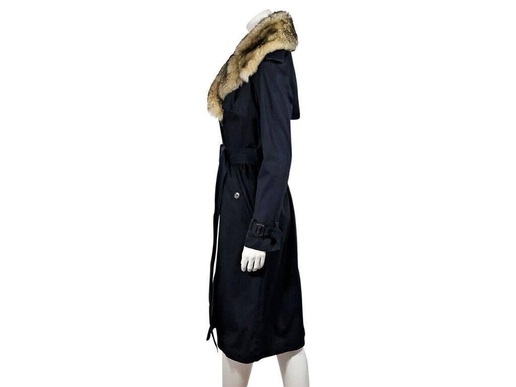 Product details:  Navy blue trench coat by Marc By Marc Jacobs.  Faux-fur trimmed notched lapel.  Long sleeves.  Double-breasted closure.  Adjustable belted waist.  Waist button pockets.  Front and back storm vents.  Back center hem vent.
Condition:
