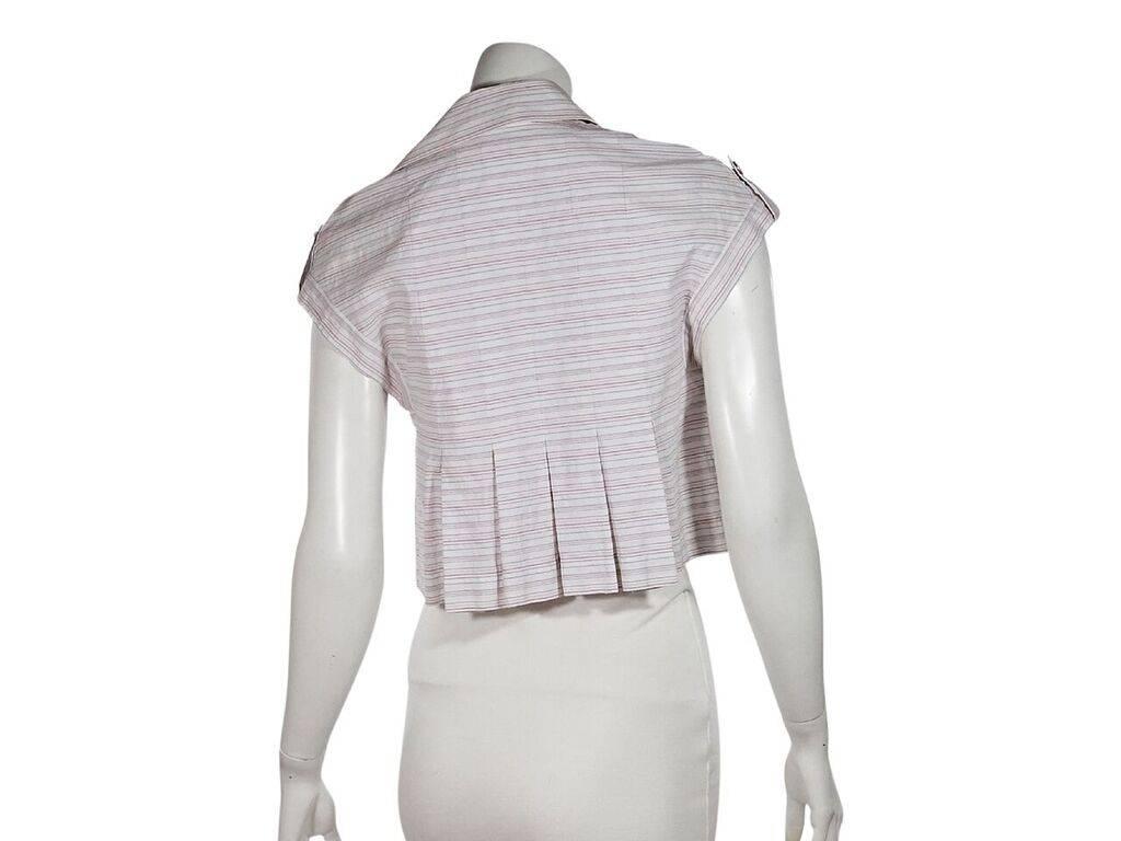 Product details:  White, red and blue striped top by Chanel.  Spread collar.  Cap sleeves.  Button tab cuffs.  Button-front closure.  Box pleated back hem.  Label size FR 34.
Condition: Pre-owned. Very good.
Est. Retail $ 798.00