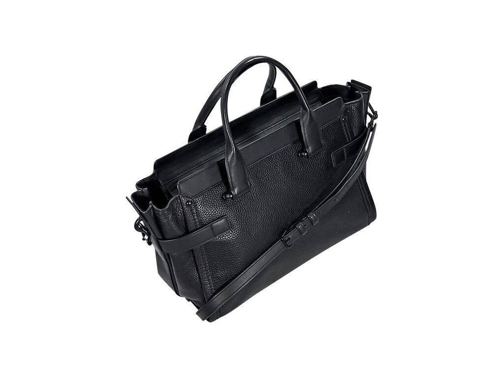 Product details:  Black pebbled leather Swagger 27 satchel by Coach.  Dual top carry handles.  Detachable, adjustable crossbody strap.  Top zip closure.  Lined interior with inner zip and slide pockets.  Exterior buckle strap accent.  Protective