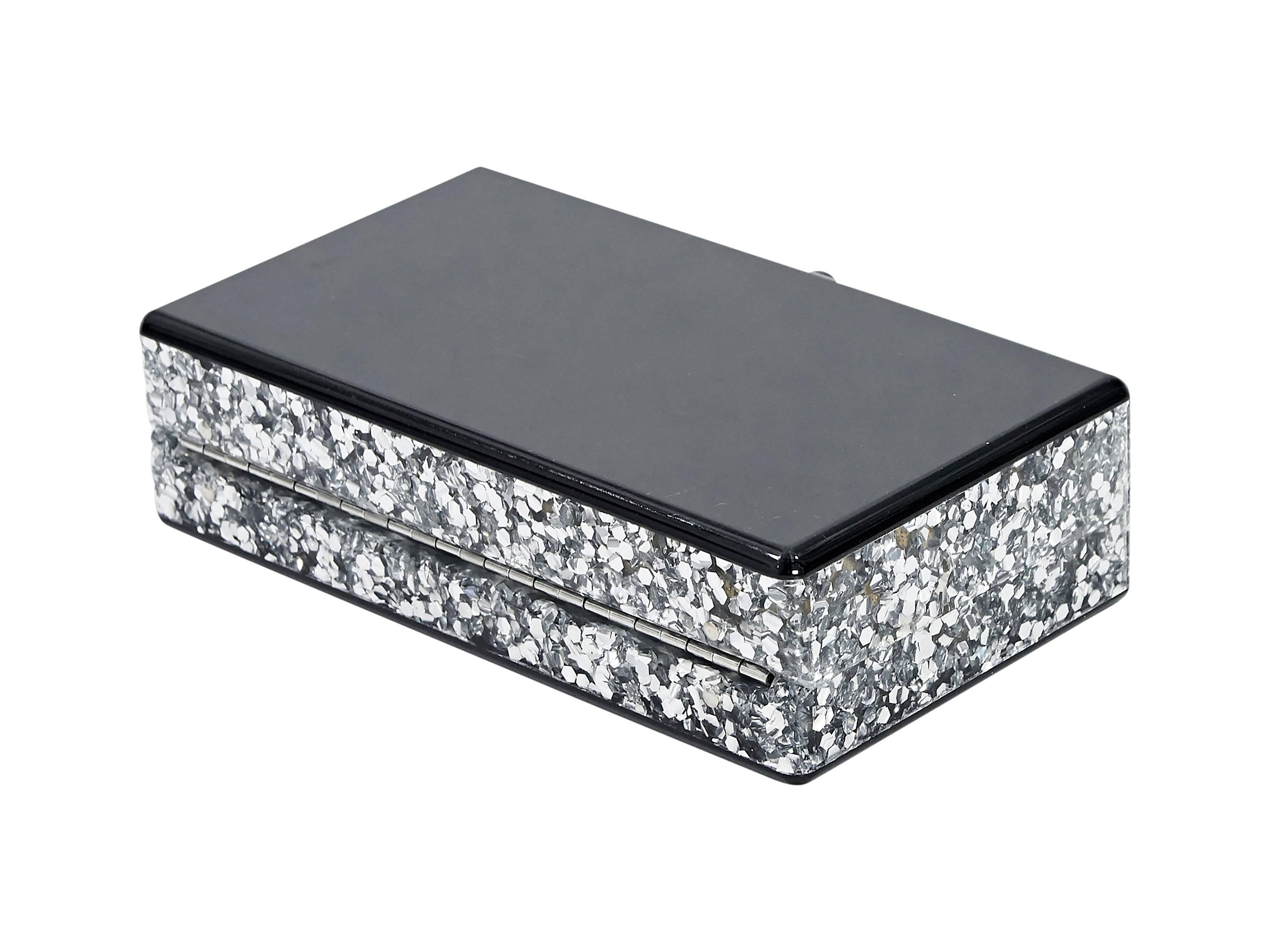 Product details:  Black acrylic box clutch by Edie Parker.  Silver glittered sides.  Top flip-lock closure.  Inner mirror.  6.75