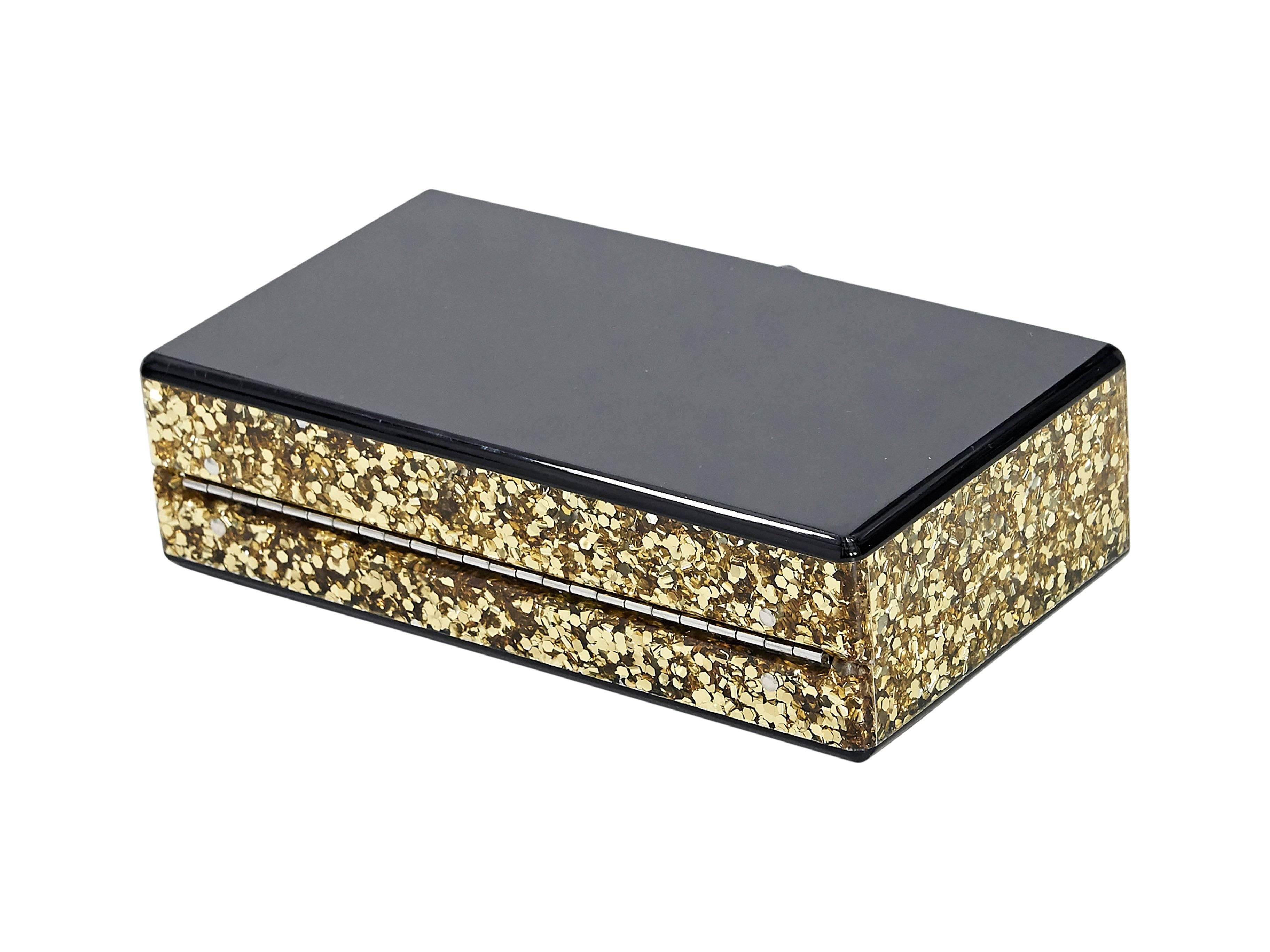 Product details:  Black acrylic box clutch by Edie Parker.  Gold glitter sides.  Top flip-lock closure.  Inner mirror.  6.75