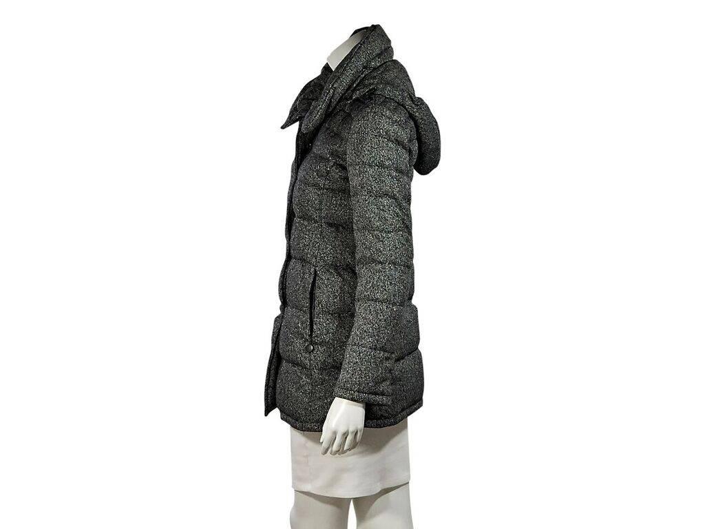 Product details:  Black and white printed puffer coat by Akris Punto.  Stand collar.  Detachable hood.  Long sleeves.  Snap-front closure.  Waist slide pockets.   
Condition: Pre-owned. Very good.
Est. Retail $ 1,490.00