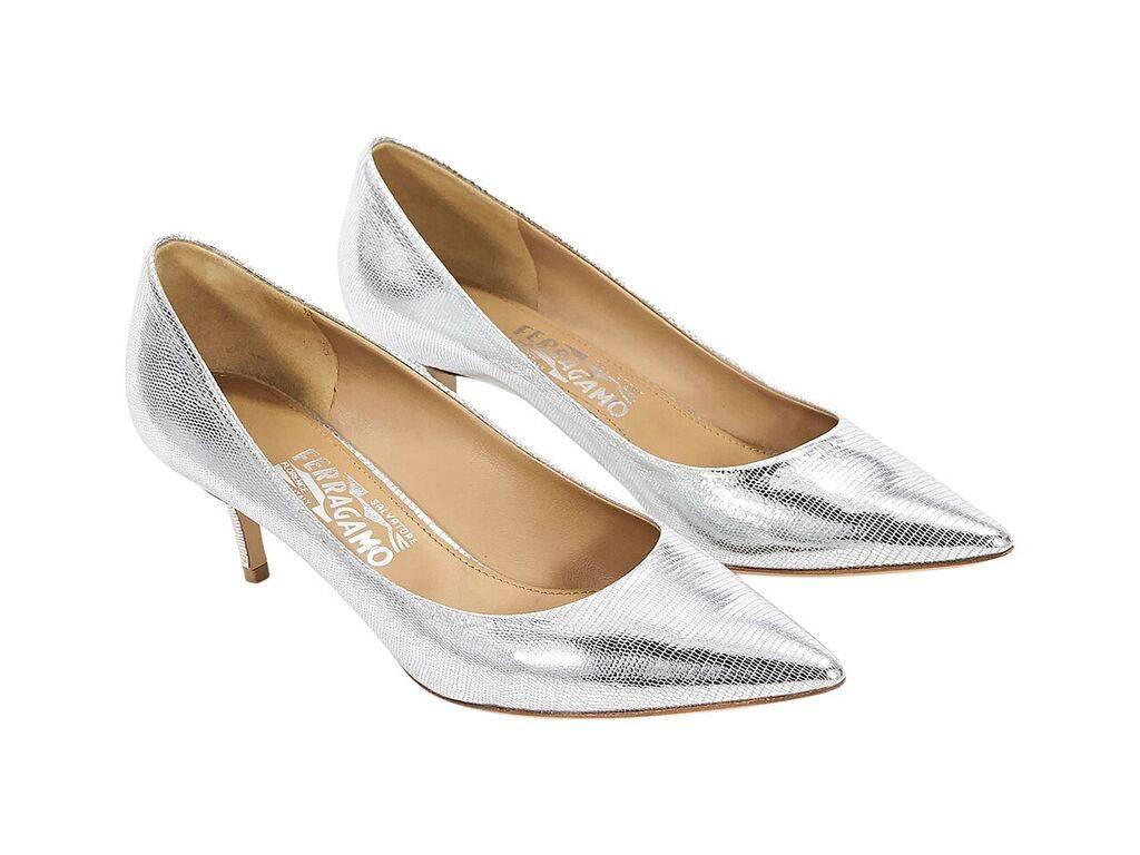Product details:  Metallic silver leather kitten heel pumps by Salvatore Ferragamo.  Point toe.  Slip-on style. 
Condition: Pre-owned. Very good.
Est. Retail $ 748.00