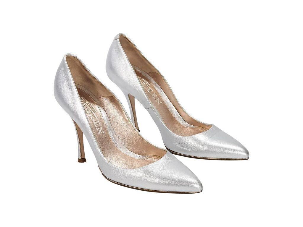 Product details:  Metallic silver leather pumps by Alexander McQueen.  Rounded point toe.  Slip-on style. 
Condition: Pre-owned. Very good.
Est. Retail $ 798.00