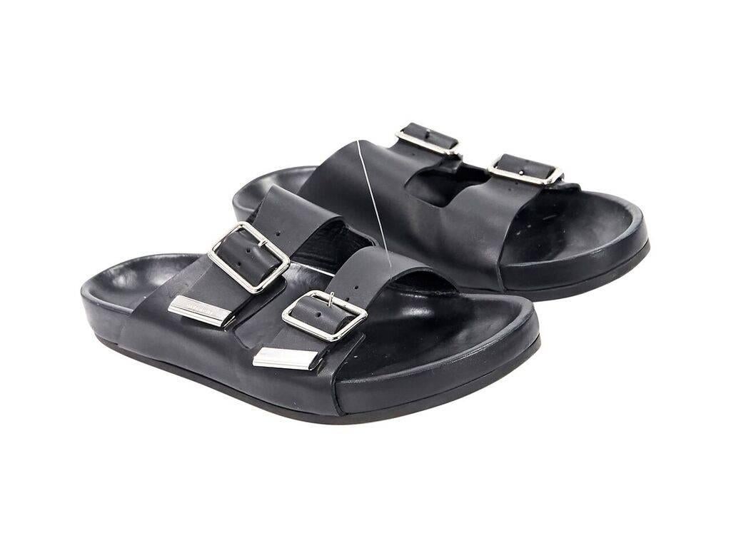 Product details:  Black leather slide sandals by Givenchy.  Double buckle straps.  Open toe.  Silvertone hardware. 
Condition: Pre-owned. Very good.
Est. Retail $ 795.00