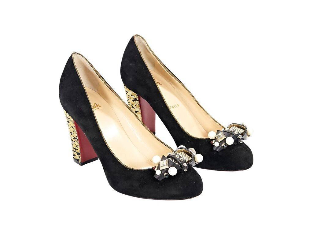 Product details:  Black suede Tudor Trott pumps by Christian Louboutin.  Embellished bow at vamp.  Round toe.  Metallic gold jacquard-covered chunky heel.  Iconic red sole.  Slip-on style. 
Condition: Pre-owned. Very good.
Est. Retail $ 895.00