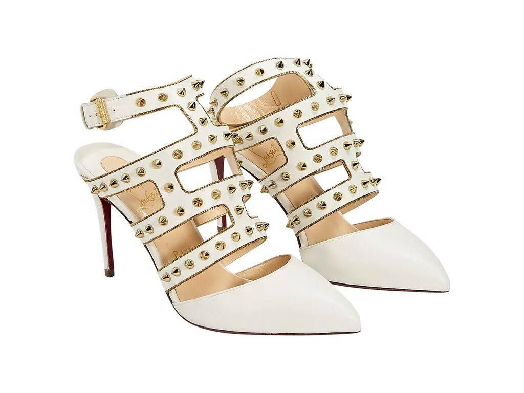 Product details:  Cream leather Tchicaboum caged pumps by Christian Louboutin.  Accented with studs and chain trim.  Adjustable ankle strap.  Point toe.  Iconic red sole.  Goldtone hardware.
Condition: Pre-owned. Very good.
Est. Retail $ 1,195.00
