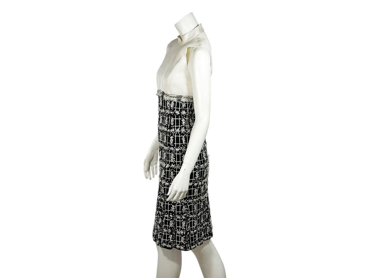 Product details:  Black and cream sheath dress by Oscar de la Renta.  Stand collar.  Sleeveless.  Concealed back zip closure.  Embellished boucle skirting.  
Condition: Pre-owned. Very good.
Est. Retail $ 1,198.00