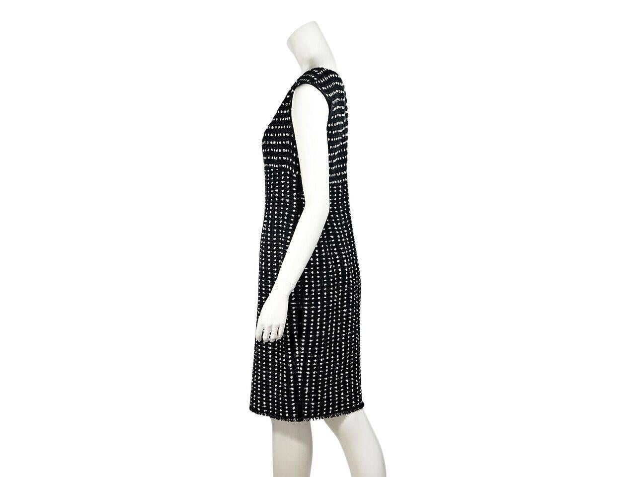 Product details:  Navy blue woven sheath dress by Escada.  Accented with white polka dots.  V-neck.  Cap sleeves.  Concealed back zip closure.  Fringed hem.  Label size IT 38.
Condition: Pre-owned. Very good.
Est. Retail $ 348.00