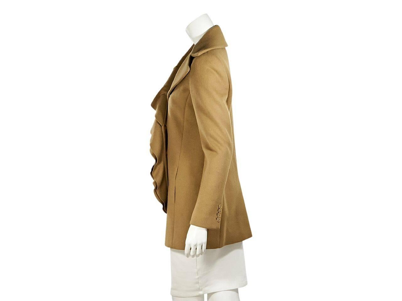 Product details:  Tan wool ruffle-trimmed coat by Elie Tahari.  Oversized notched lapel.  Long sleeves.  Four-button detail at cuffs.  Double-breasted button-front closure.  On-seam slide waist pockets.  Back center hem vent. 
Condition: Pre-owned.