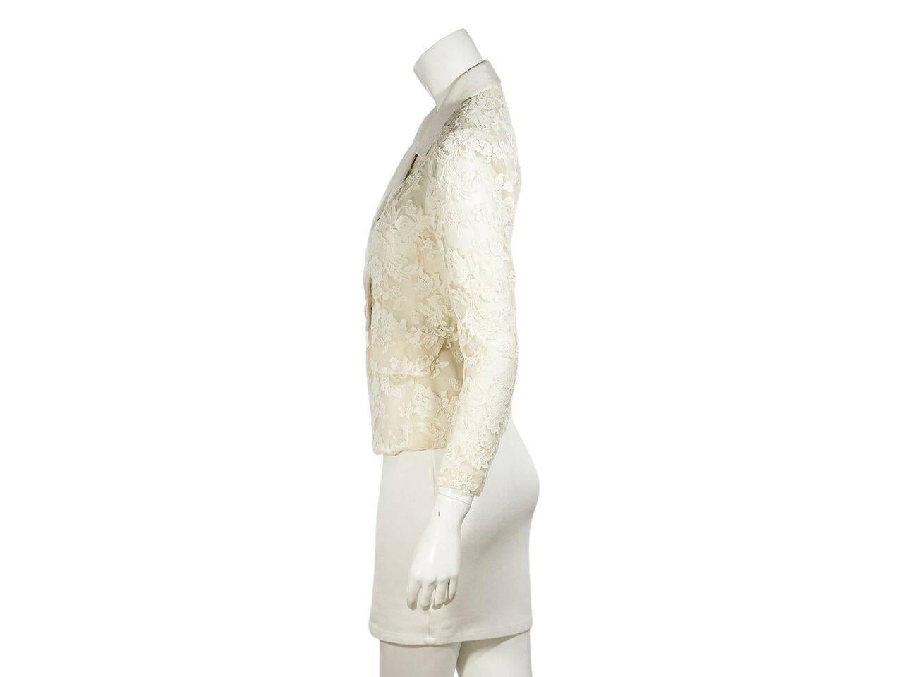 Product details:  White vintage lace blazer by Yves Saint Laurent.  Notched lapel.  Bracelet-length sleeves.  Single-button closure.  Waist flap pockets.  
Condition: Pre-owned. Very good.
Est. Retail $ 998.00