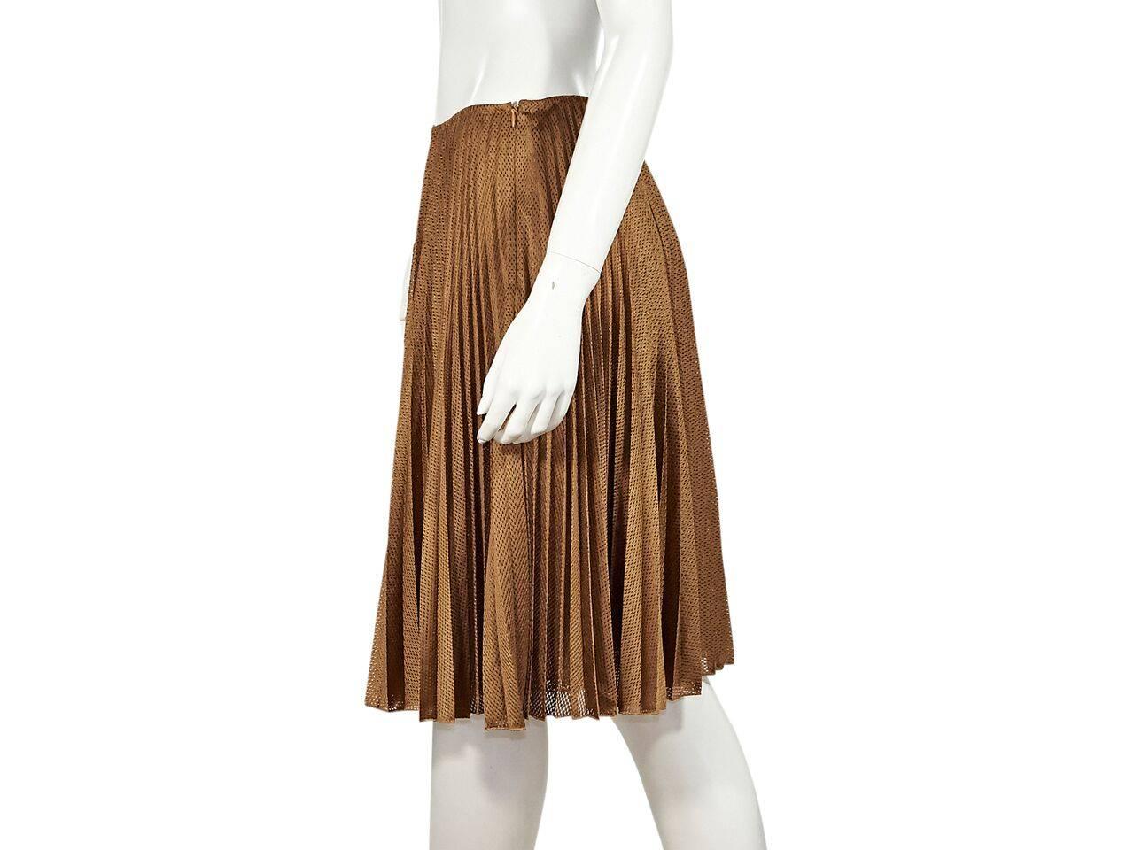 Product details:  Copper perforated nylon pleated skirt by Prada.  Concealed side zip closure. 
Condition: Pre-owned. Very good.
Est. Retail $ 498.00