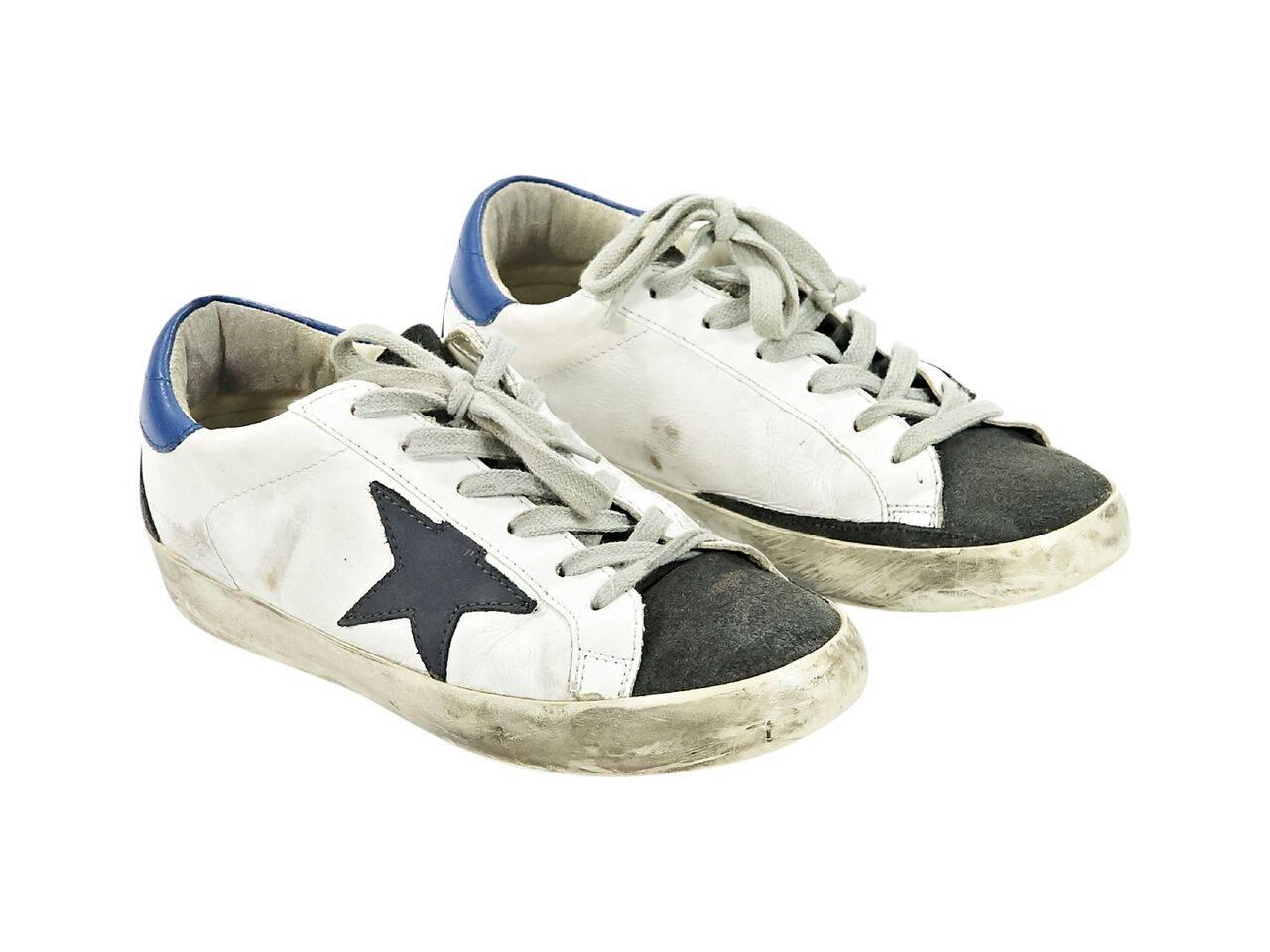 Product details:  White, blue and grey leather sneakers by Golden Goose Deluxe Brand.  Intentional distressed design.  Lace-up closure.  Round suede toe.  
Condition: Pre-owned. Very good.
Est. Retail $ 585.00