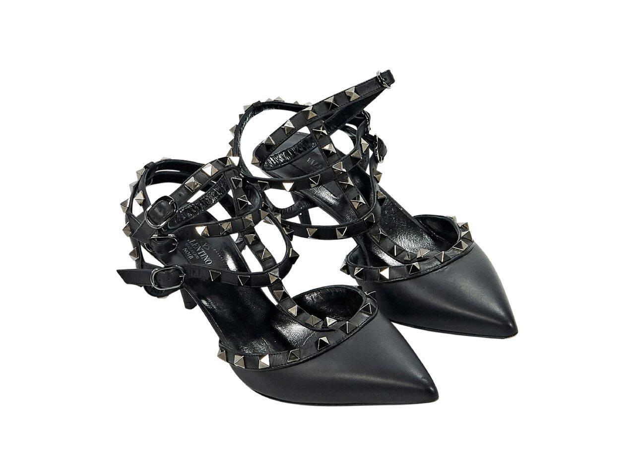 Product details:  Black leather Rockstud kitten heels by Valentino.  Accented with pyramid studs.  Triple adjustable ankle straps.  Point toe.  Gunmetal-tone hardware. 
Condition: Pre-owned. Very good.
Est. Retail $ 995.00