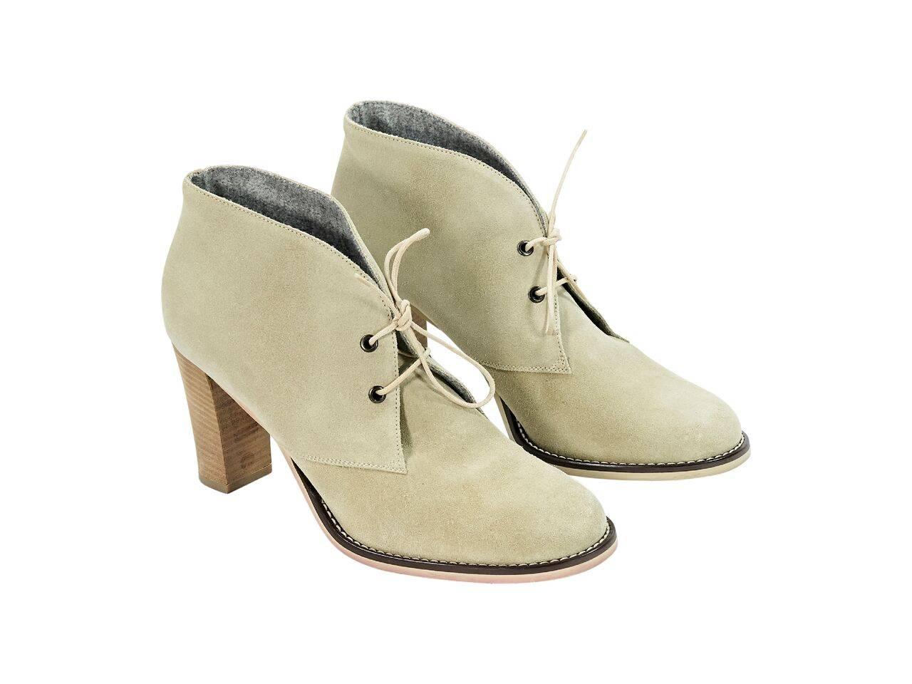 Product details:  Tan suede ankle boots by Brunello Cucinelli.  Lace-up closure.  Round toe.  Stacked block heel.  
Condition: Pre-owned. Very good.
Est. Retail $ 1,028.00