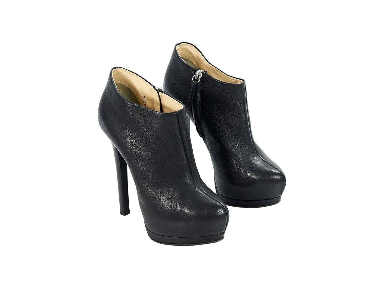Product details:  Black leather platform ankle boots by Giuseppe Zanotti.  Inner zip closure.  Almond toe.  Towering stiletto heel and platform design. 
Condition: Pre-owned. Very good.
Est. Retail $ 1,025.00