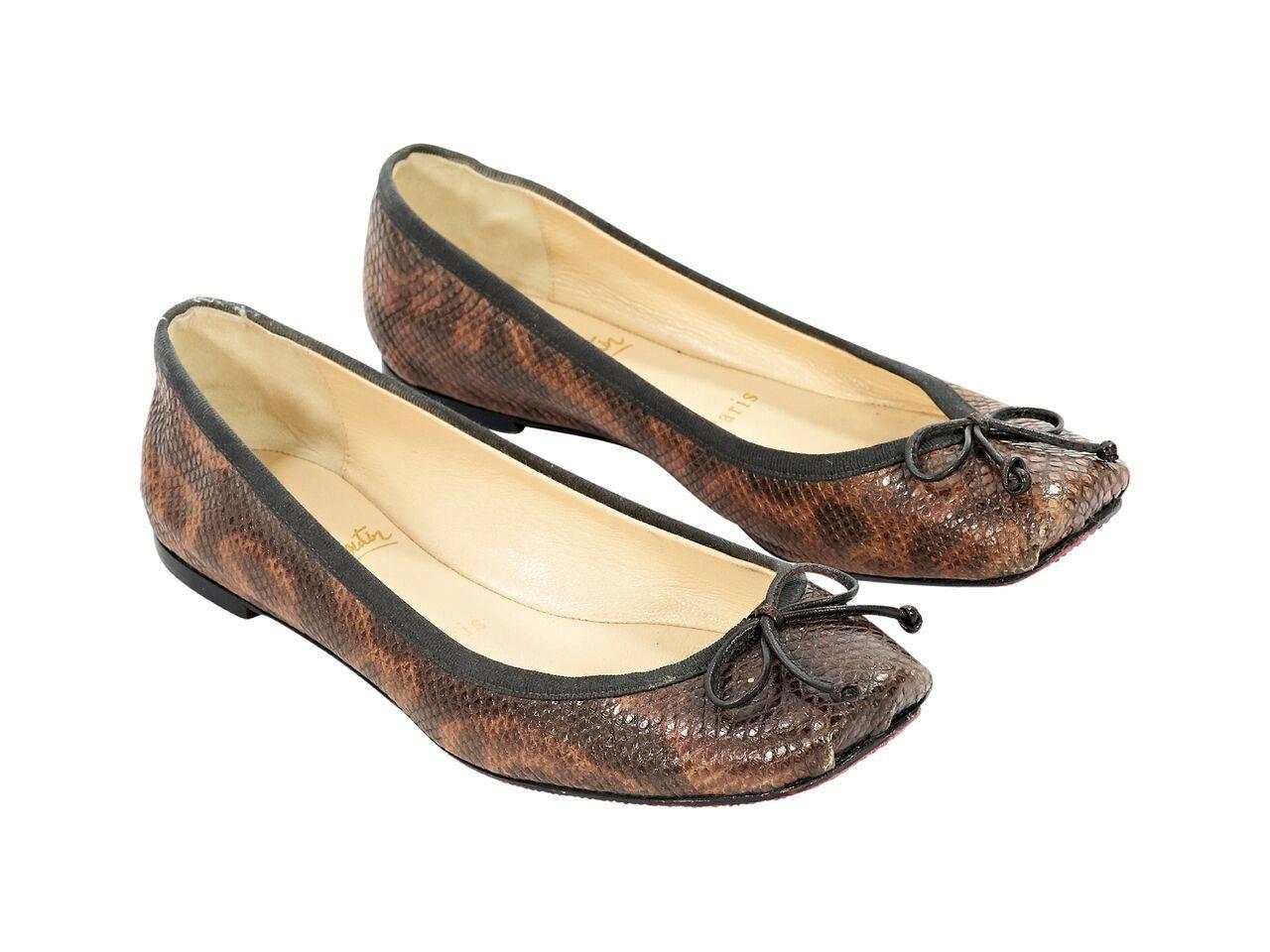 Product details:  Brown snakeskin ballet flats by Christian Louboutin.  Bow accents vamp.  Rounded square toe.  Iconic red sole.  Slip-on style. 
Condition: Pre-owned. Very good.
Est. Retail $ 998.00