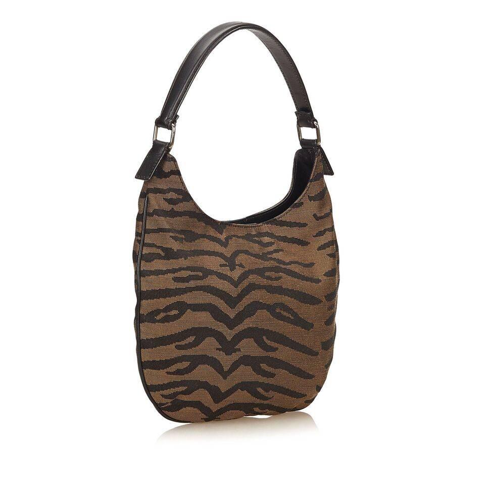 Product details:  Brown zebra jacquard hobo bag by Fendi.  Single leather shoulder strap.  Magnetic snap closure.  Lined interior with inner zip pocket.  Goldtone hardware.  11