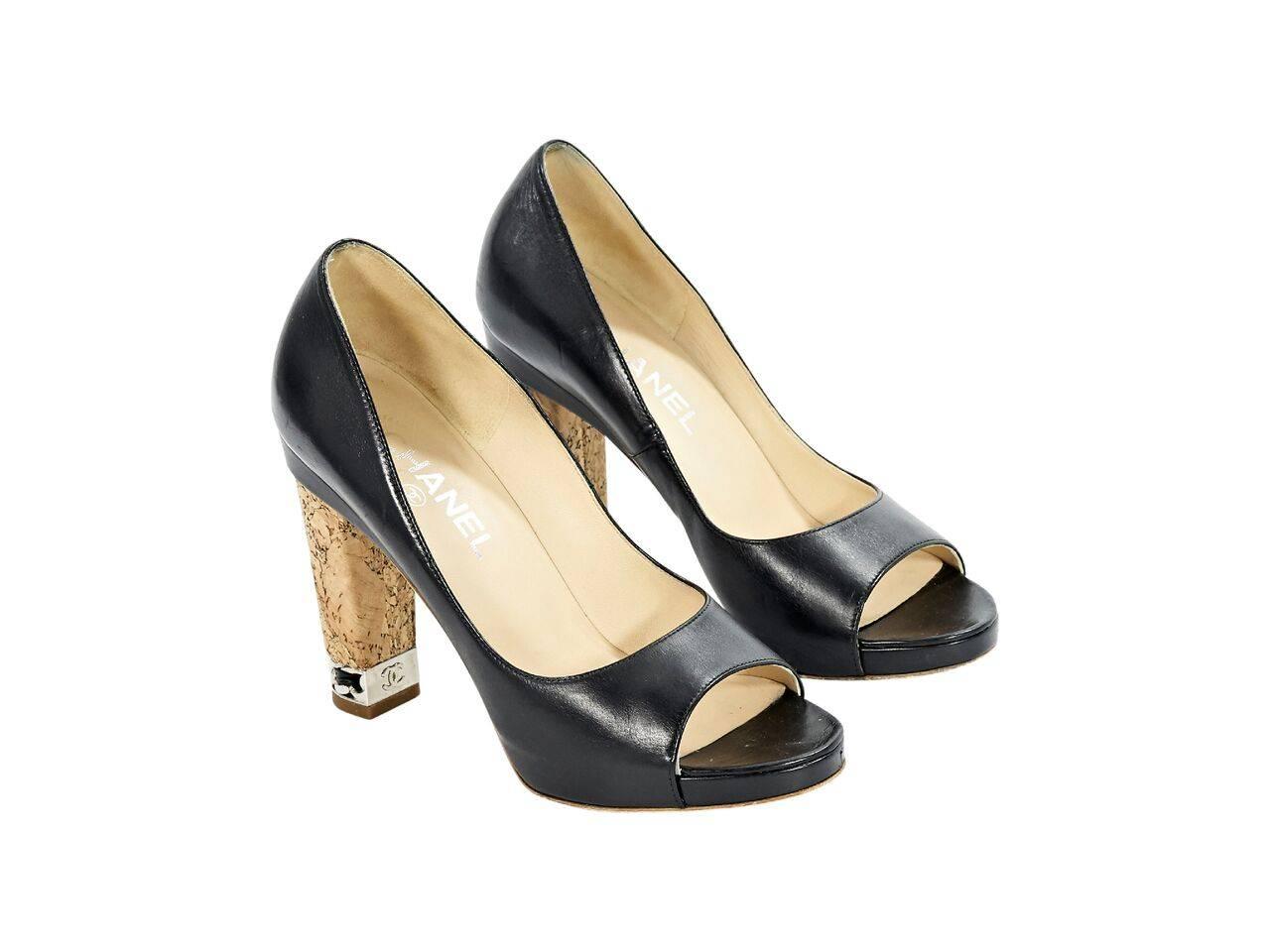 Product details:  Black leather pumps by Chanel.  Open toe.  Cork heel with chain accents.  Slip-on style.  Silvertone hardware.  
Condition: Pre-owned. Very good.
Est. Retail $ 1,100.00
