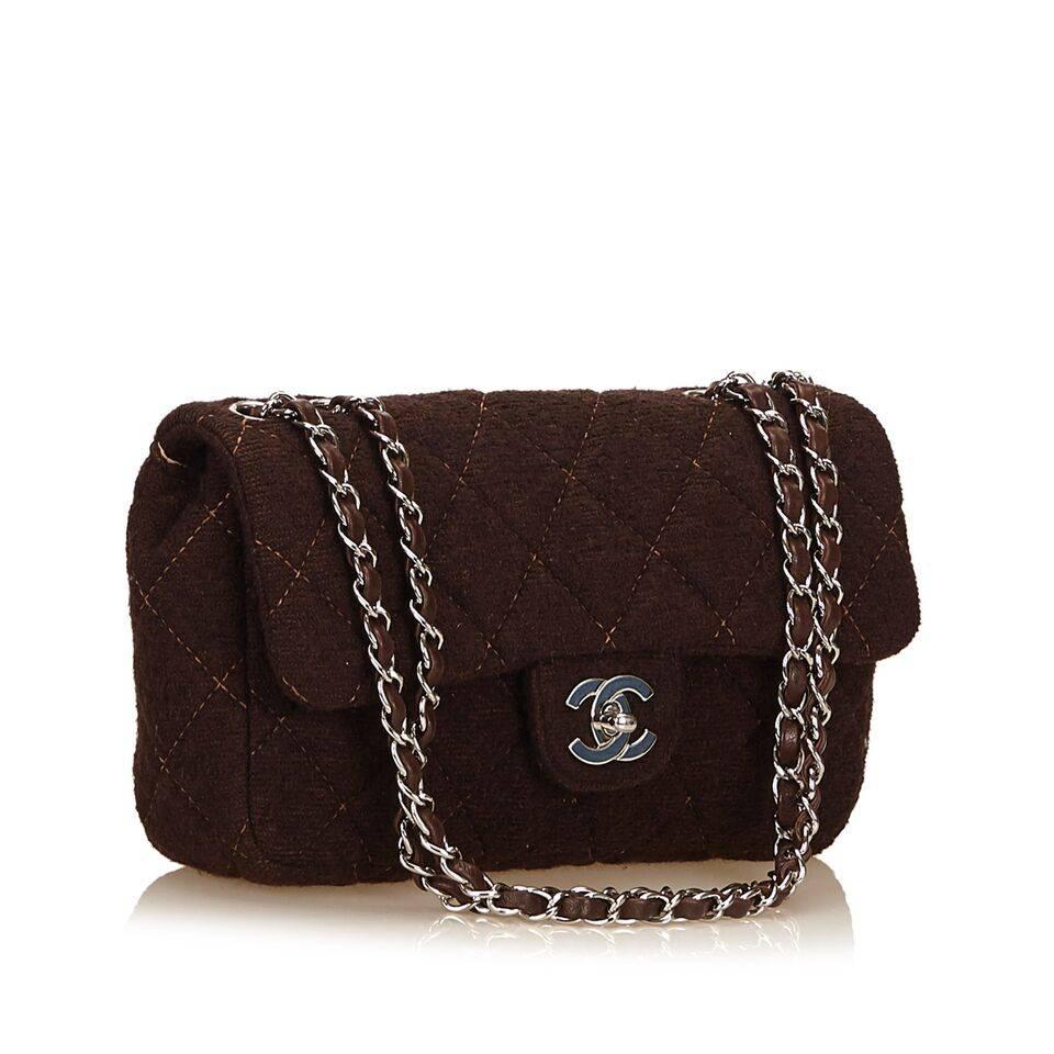 Product details:  Brown quilted wool Matelasse flap bag by Chanel.  Dual shoulder straps.  Front flap with logo twist-lock closure.  Lined interior with inner zip pocket.  Silvertone hardware.  Dust bag included.  10