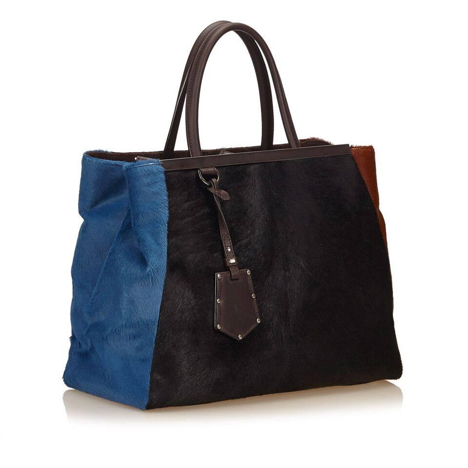 Product details:  Multicolor pony hair 2Jours tote bag by Fendi.  Dual leather carry handles.  Snap tab closure.  Lined interior with inner center zip compartment and inner slide pockets.  Protective metal feet.  Silvertone hardware.  
Condition: