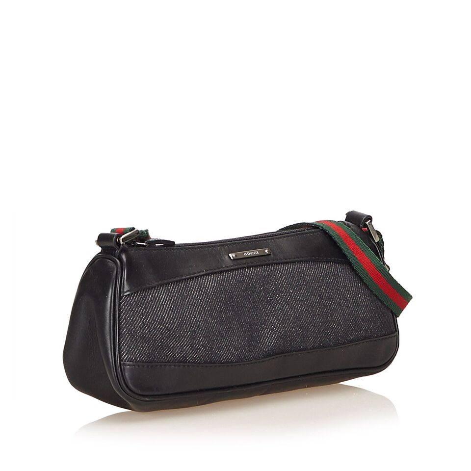 Product details:  Black denim shoulder bag by Gucci.  Trimmed with leather.  Single shoulder strap.  Top zip closure.  8