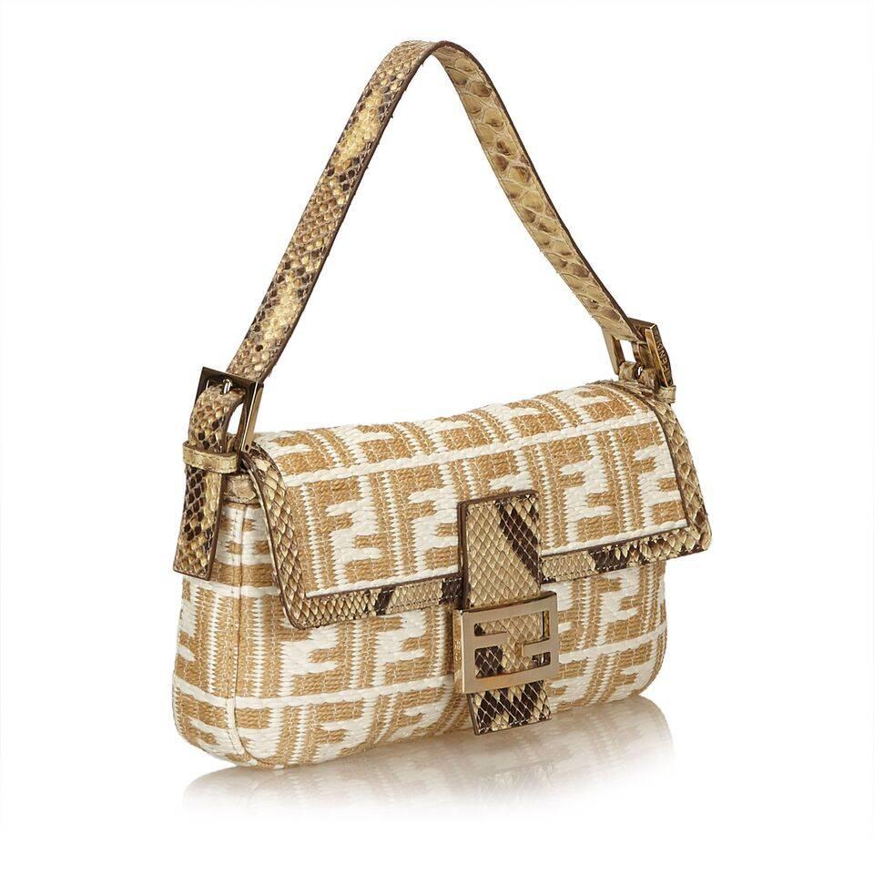 Product details:  Tan and white woven Zucca baguette bag by Fendi.  Trimmed with python skin.  Single shoulder strap.  Front flap with magnetic snap closure.  Lined interior with inner zip pocket.  10