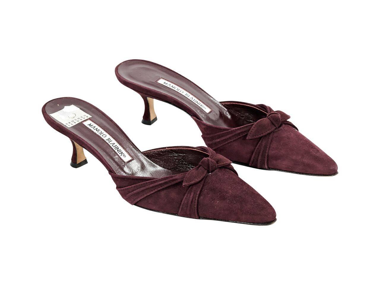 Product details:  Burgundy suede mules by Manolo Blahnik.  Bow and pleats accent vamp.  Point toe.  Low kitten heel.  Slip-on style. 
Condition: Pre-owned. Very good.
Est. Retail $ 398.00