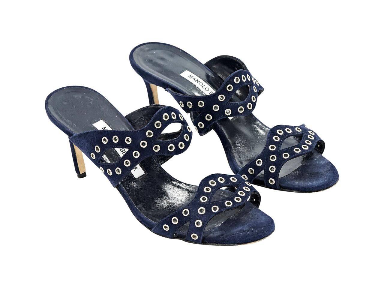 Product details:  Navy blue suede sandals by Manolo Blahnik.  Accented with grommmets.  Open toe.  Slip-on style.  Silvertone hardware. 
Condition: Pre-owned. Very good.
Est. Retail $ 428.00