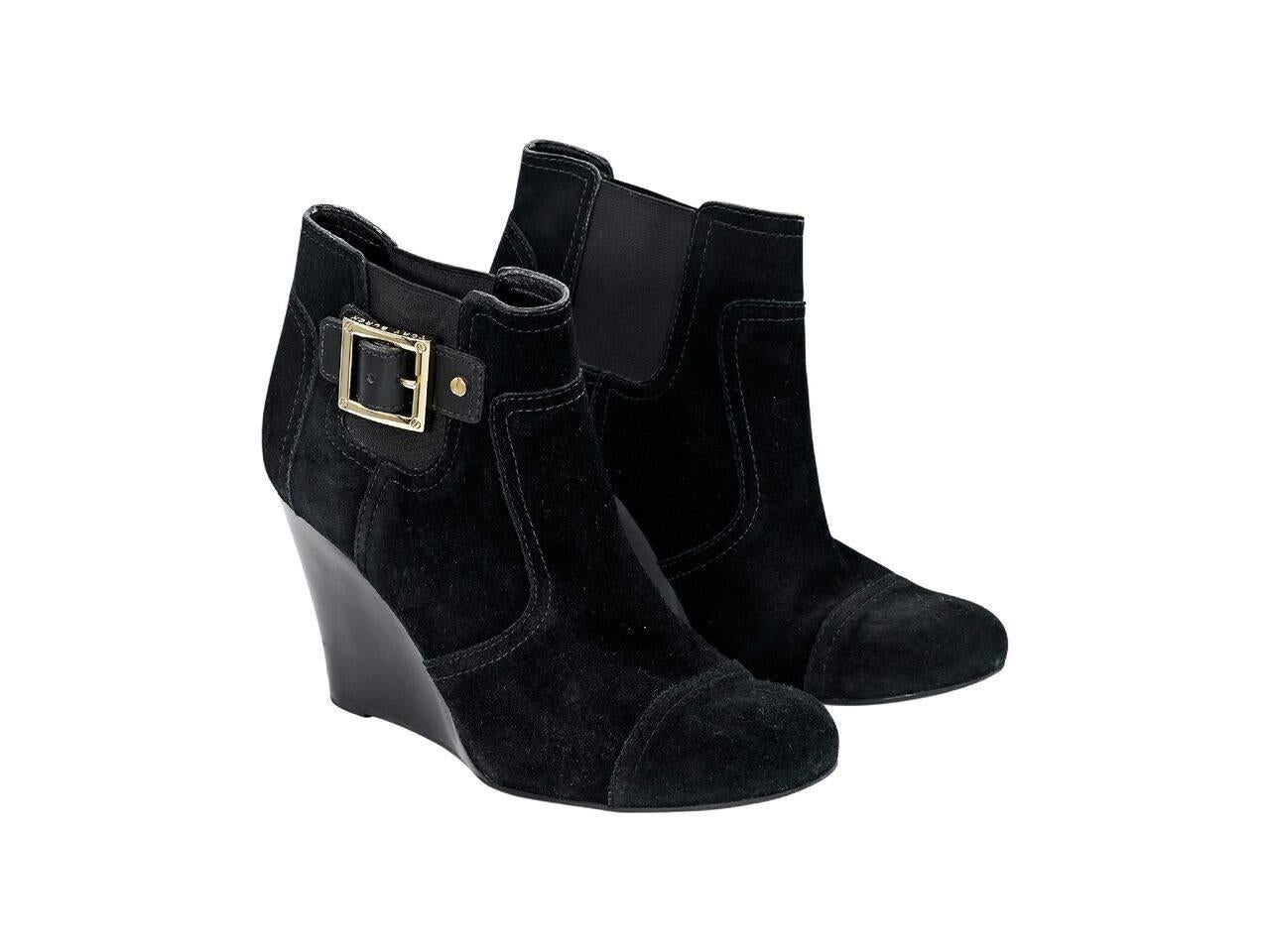 Product details:  Black suede wedge ankle boots by Tory Burch.  Elasticized side panels for an easy fit.  Round cap toe.  Slip-on style.  Goldtone hardware.
Condition: Pre-owned. Very good.
Est. Retail $ 498.00