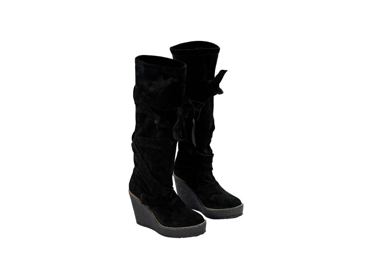 Product details:  Black suede wedge tall boots by Robert Clergerie.  Accented with a wrap-around strap.  Round toe.  Pull-on style.  
Condition: Pre-owned. Very good.
Est. Retail $ 928.00