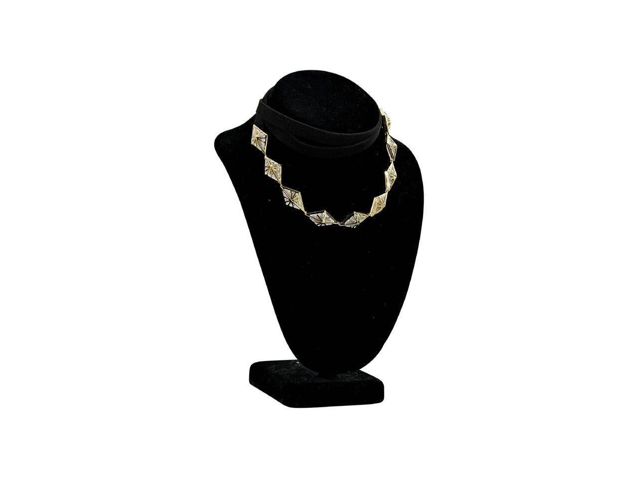 Product details:  Crystal charm choker necklace by Noir Jewelry.  Adjustable tie closure.  Goldtone hardware.  69