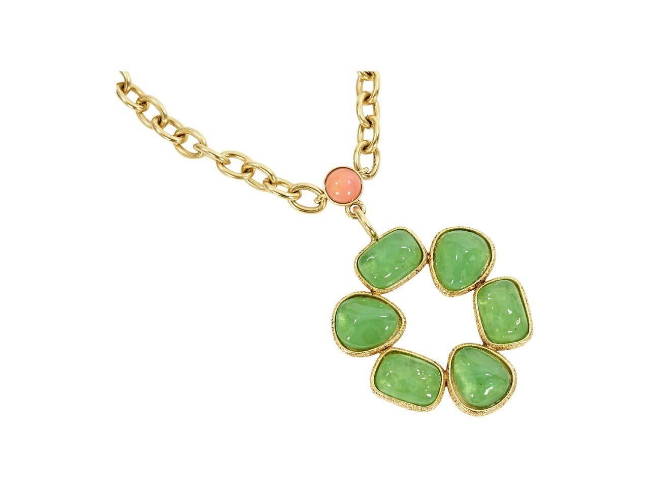 Product details:  Vintage pendant necklace by Gerard Yosca.  Single chain strand.  Circular pendant set with green stones.  Goldtone hardware.  18.75