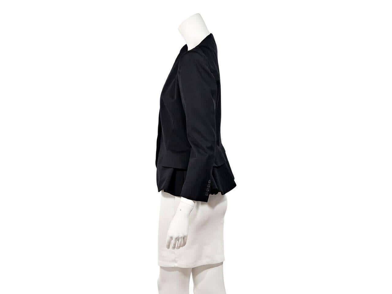 Product details:  Black peplum waist blazer by Alexander McQueen.  Bracelet-length sleeves.  Four-button detail at cuffs.  Concealed front closure.  Side waist flaps.  Label size IT 46.
Condition: Pre-owned. Very good.
Est. Retail $ 1,975.00