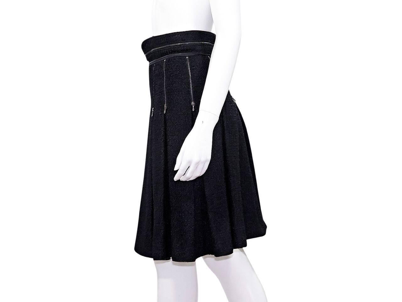 Product details:  Navy blue pleated A-line skirt by Chanel.  Accented with zipper details.  Banded waist.  Side zip closure.  Label size FR 40.
Condition: Pre-owned. Very good.
Est. Retail $ 1,028.00