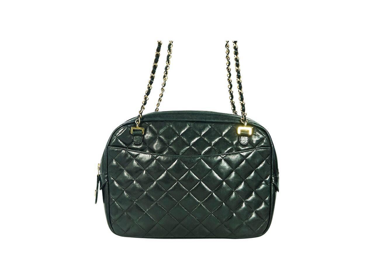 Product details:  Black vintage quilted lambskin leather crossbody bag by Chanel.  Dual crossbody straps.  Top zip closure.  Leather lined interior with inner zip and slide pockets.  Exterior front and back slide pockets.  Goldtone hardware.  