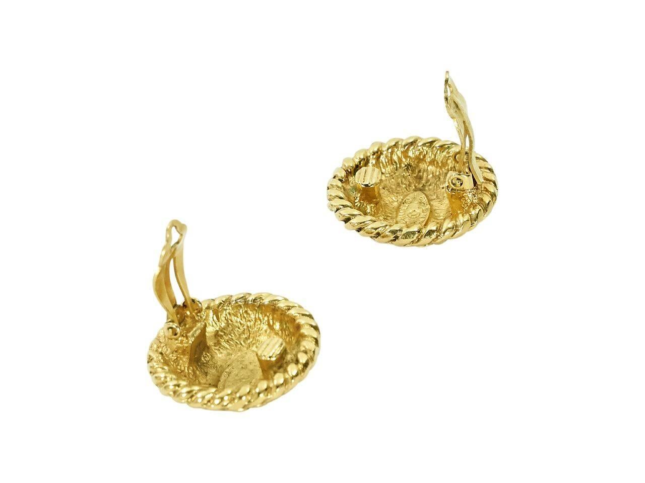 Product details:  Vintage goldtone clip-on earrings by Chanel.  Circular design with CC logo center.  1