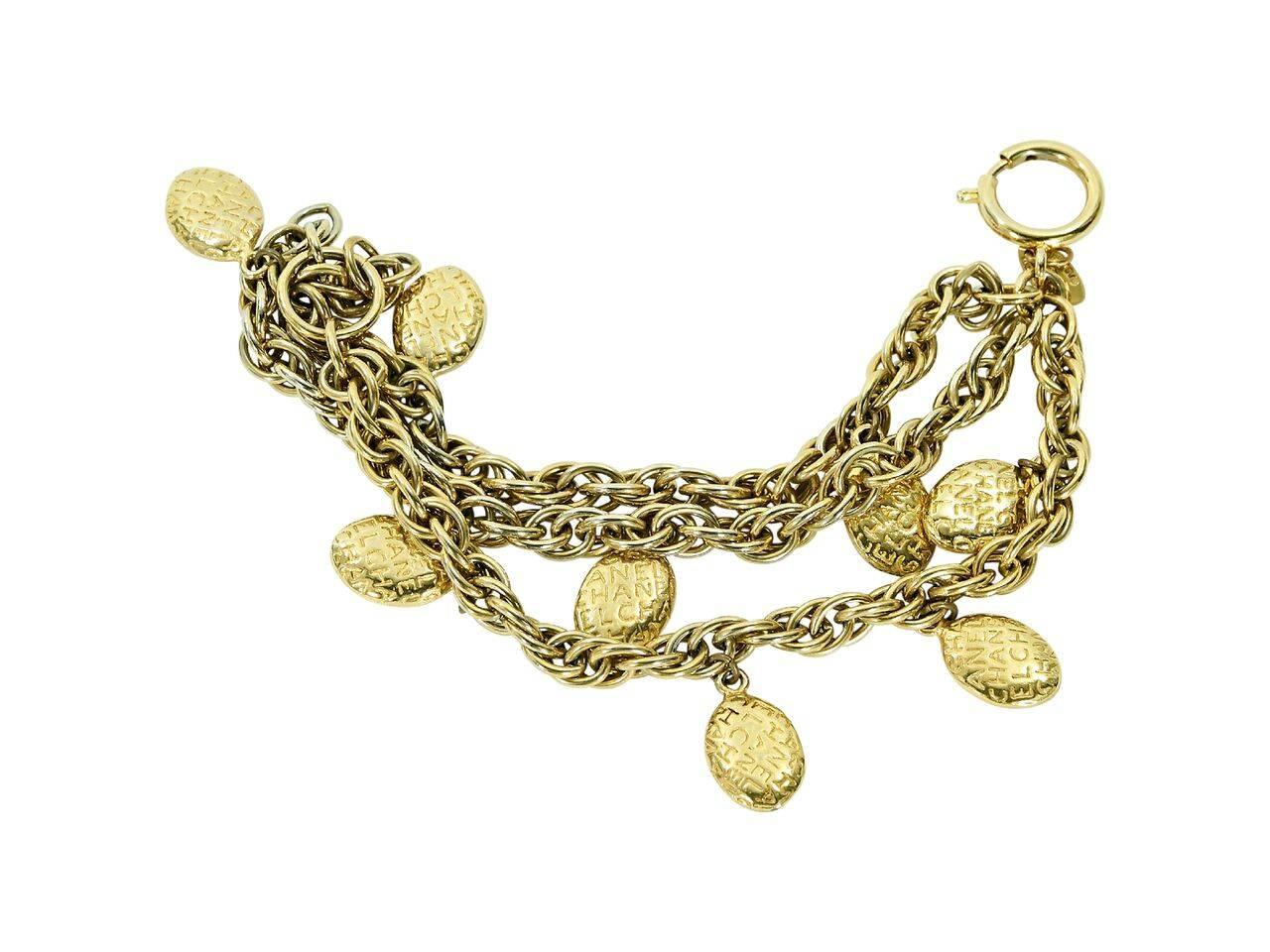 Product details:  Vintage goldtone charm bracelet by Chanel.  Multi-strand design.  Spring ring closure.  7.25