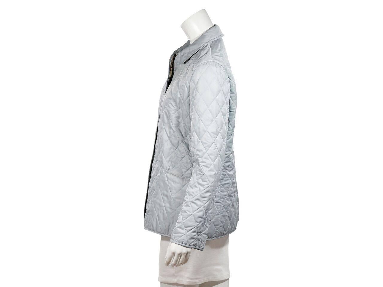 Product details:  Light blue quilted jacket by Burberry London.  Spread collar.  Long sleeves.  Snap-front closure.  Waist patch pockets.  
Condition: Pre-owned. Very good.
Est. Retail $ 998.00