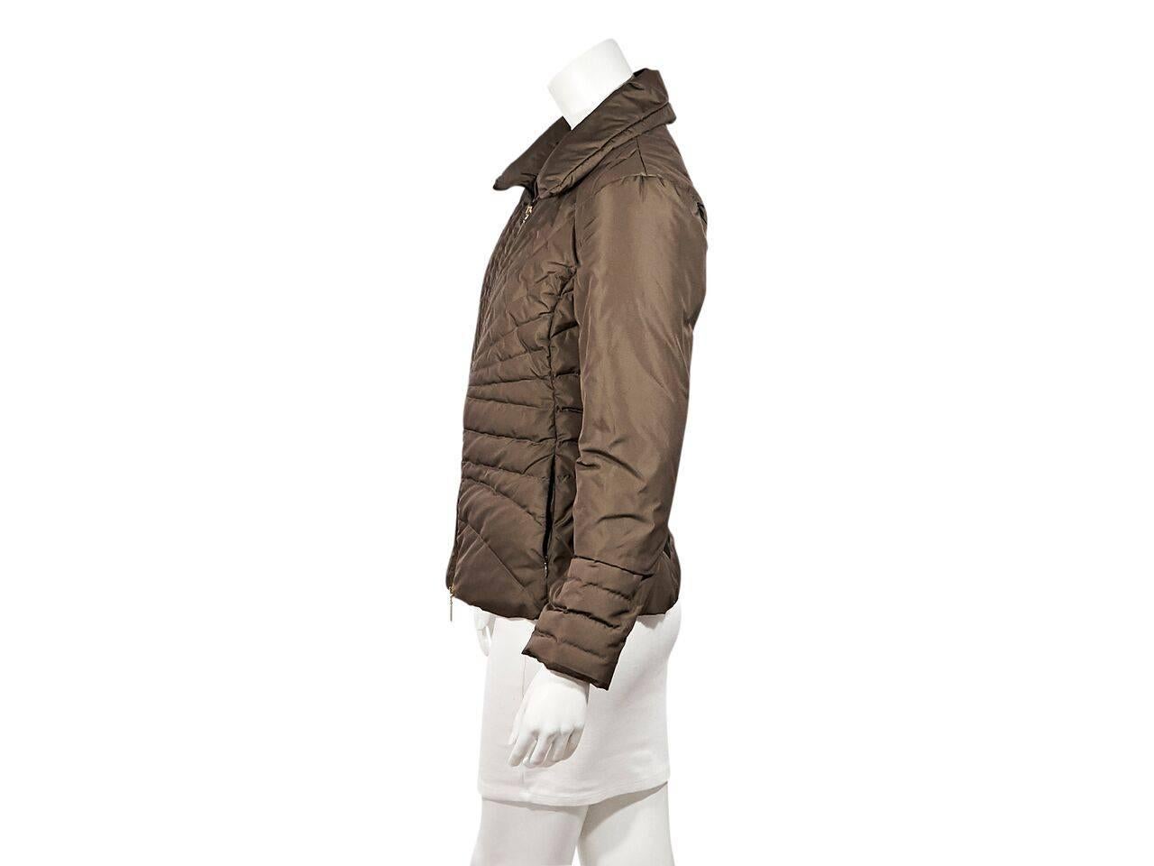 Product details:  Brown puffer coat by Moncler.  Spread collar.  Long sleeves.  Zip-front closure.  Concealed zip waist pockets. 
Condition: Pre-owned. As is.
Est. Retail $ 1,098.00