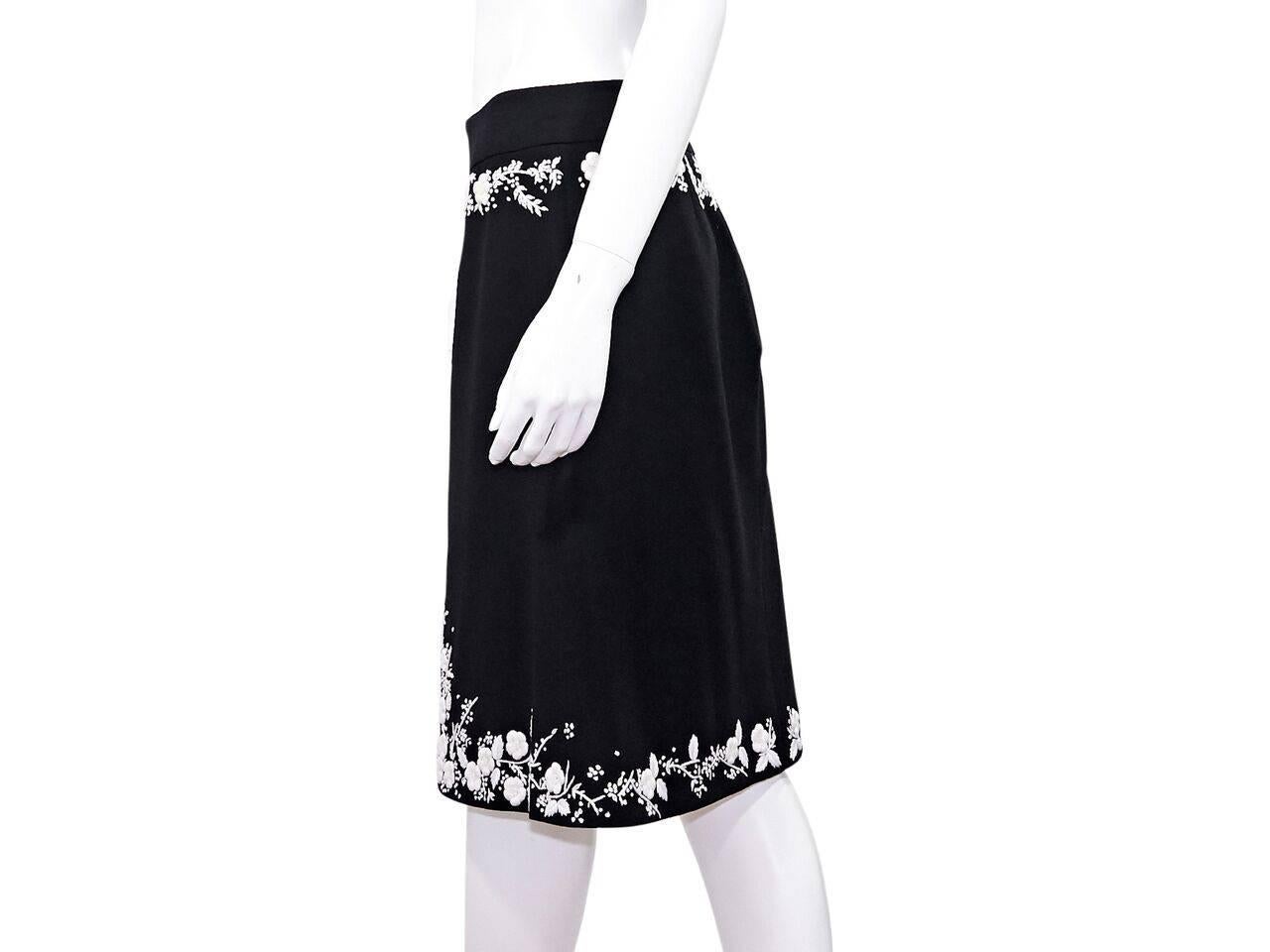 Product details:  Black and white embroidered A-line skirt by Alexander McQueen.  Banded waist.  Concealed back zip closure.  Label size IT 42.  
Condition: Pre-owned. Very good.
Est. Retail $ 695.00