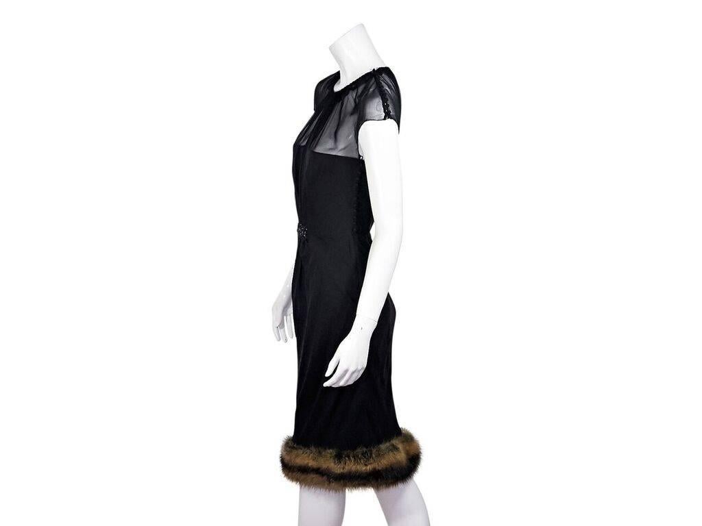 Product details:  Black illusion-neck sheath dress by J. Mendel.  Roundneck.  Cap sleeves.  Embellished front gathering.  Side button closure.  Fox fur trimmed hem.
Condition: Pre-owned. Very good.
Est. Retail $ 3,000.00