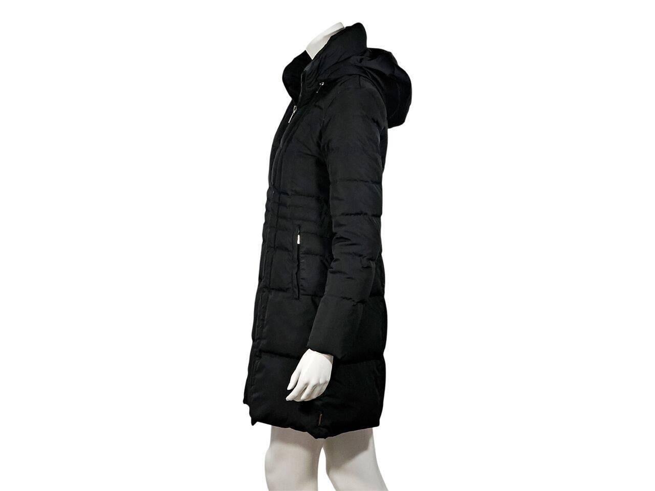 Product details:  Black puffer coat by Moncler.  Detachable hood.  Long sleeves.  Zip-front closure.  Waist zip pockets.  Seamwork creates a flattering silhouette. 
Condition: Pre-owned. Very good.
Est. Retail $ 998.00