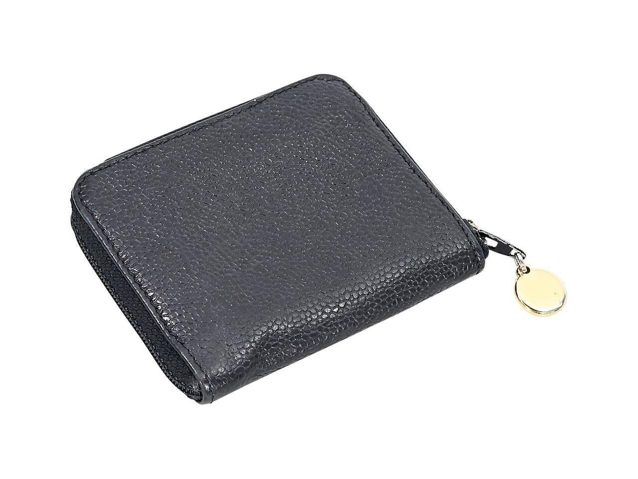 Product details:  Black caviar leather timeless wallet by Chanel.  Front embossed logo.  Zip around closure.  Lined interior with two inner compartments.  4