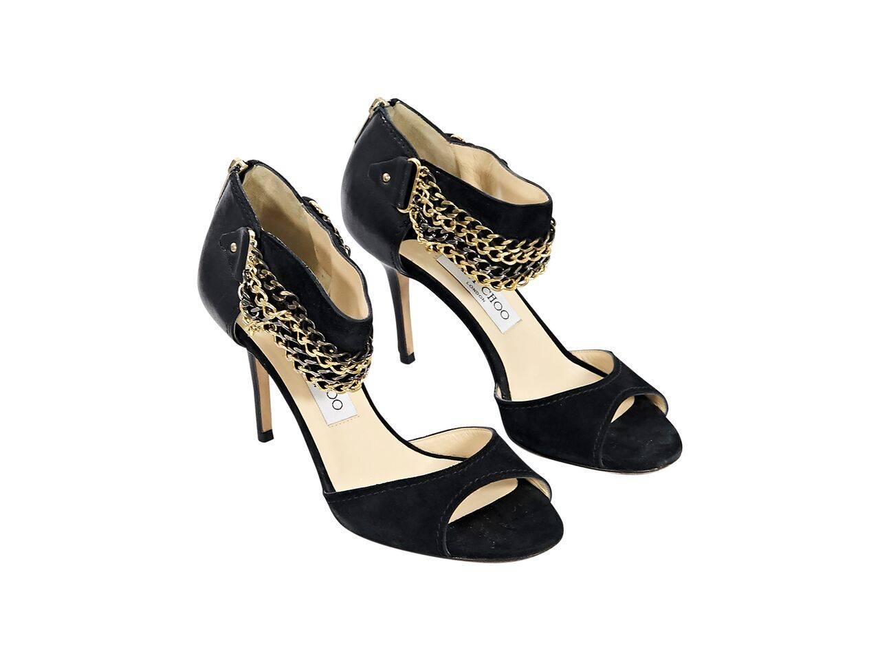 Product details:  Black leather and suede pumps by Jimmy Choo.  Ankle strap embellished with multiple chains.  Open toe.  Back zip closure.  Multi-tone hardware.  
Condition: Pre-owned. Very good.
Est. Retail $ 675.00