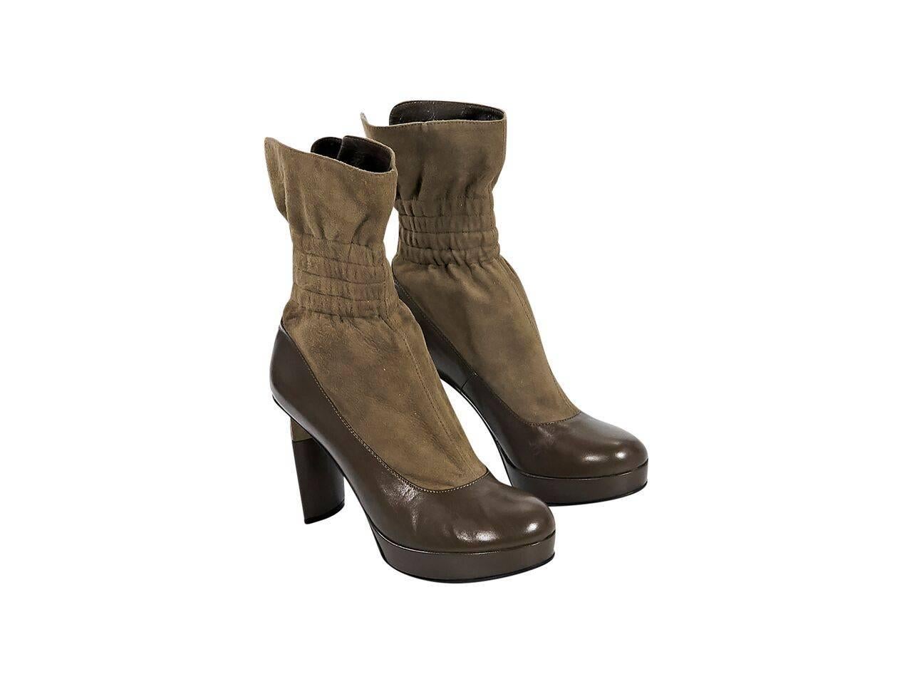 Product details:  Taupe suede and leather boots by Fendi.  Elasticized ankle cuff.  Round toe.  Triangular block heel.  Back zip closure.  
Condition: Pre-owned. Very good.
Est. Retail $ 1,000.00